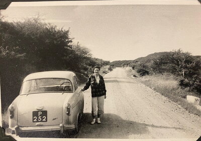 Barbara Yates with the Austin 4A she drove across the Sahara Desert and Sahel region of West Africa. N.d. but 1959. 